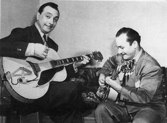 Django Reinhardt playing guitar during his tour with Duke Ellington