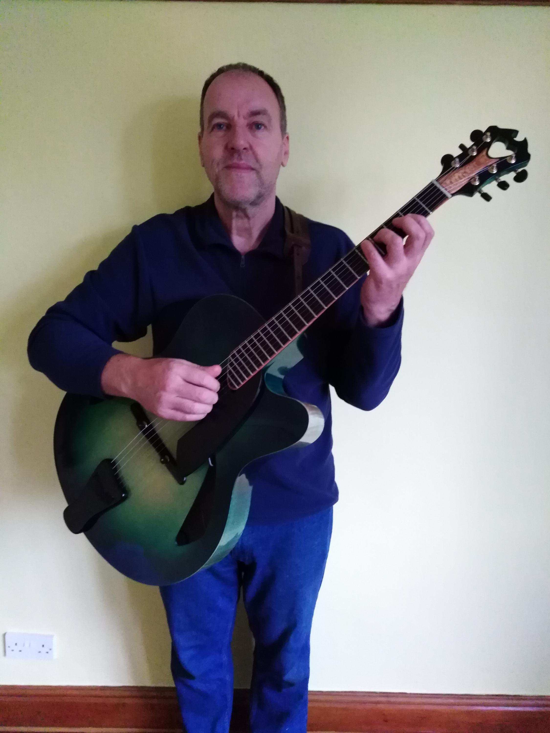 Green (Blue) Archtop-guy-holding-green-guitar-nov-2024-jpg