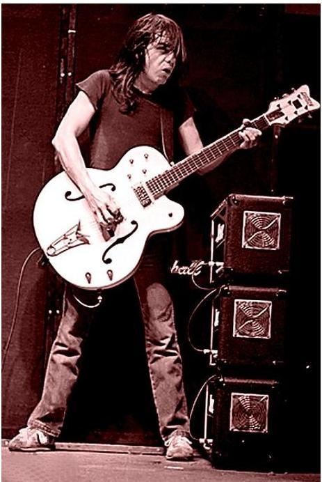 How difficult would an 18 inch guitar be for someone 5'3"?-23529-malcolm-young-playing-strat-malcom-falcon-jpeg